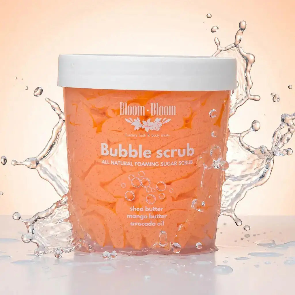 Bloom-Bloom Bubble Scrub with mango butter, shea butter, and avocado oil. Foaming sugar scrub in a clear tub with water splashes.