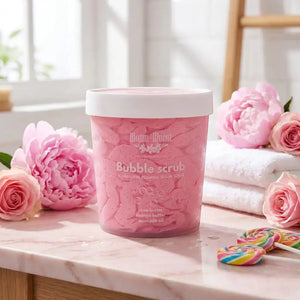 Bloom-Bloom Bubble Scrub, a pink foaming sugar scrub with mango butter, shea butter, and avocado oil. Features lollipops and flowers.