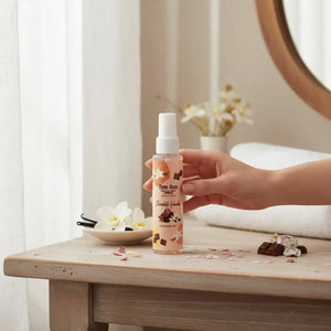 Bloom-Bloom Luxury Bath & Body treats Chocolate Vanilla Hair & Body Mist with Panthenol & Aloe Vera, 100ml bottle held by hand.