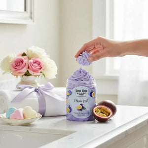 Bloom-Bloom Luxury Bath & Body treats Passion Fruit creamy body wash with shea butter, 250gr. A hand holds a dollop of purple whipped body wash.