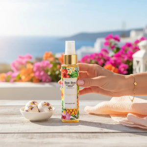 Bloom-Bloom Luxury Bath & Body treats Tropicana Hair & Body Mist with tropical fruit and flower design, 100ml bottle held by a hand.